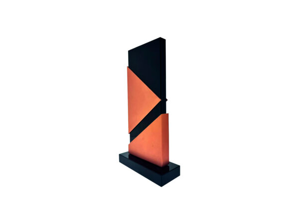 Abstract geometric sculpture with black and orange triangles.