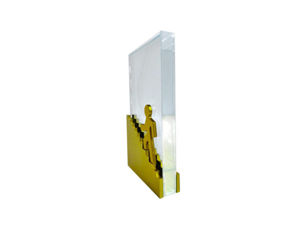 Modern sculpture of person ascending golden stairs